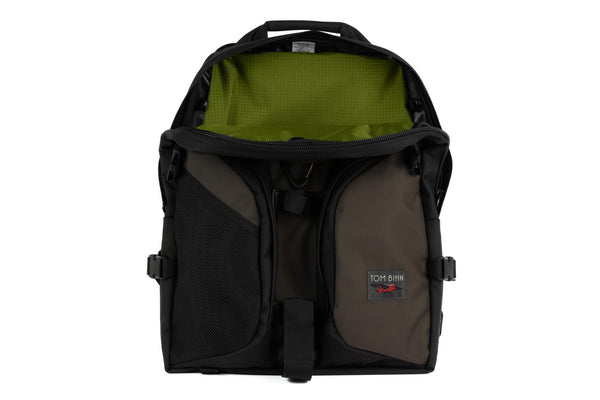 The Brain Bag in Ursa (brown-grey) Ballistic with the front main compartment zipper opened to reveal its Moss (dark green with green grid) 210 Cerylon interior.
